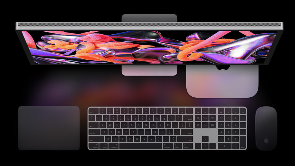 Mac mini paired with a widescreen Studio Display and Magic accessories