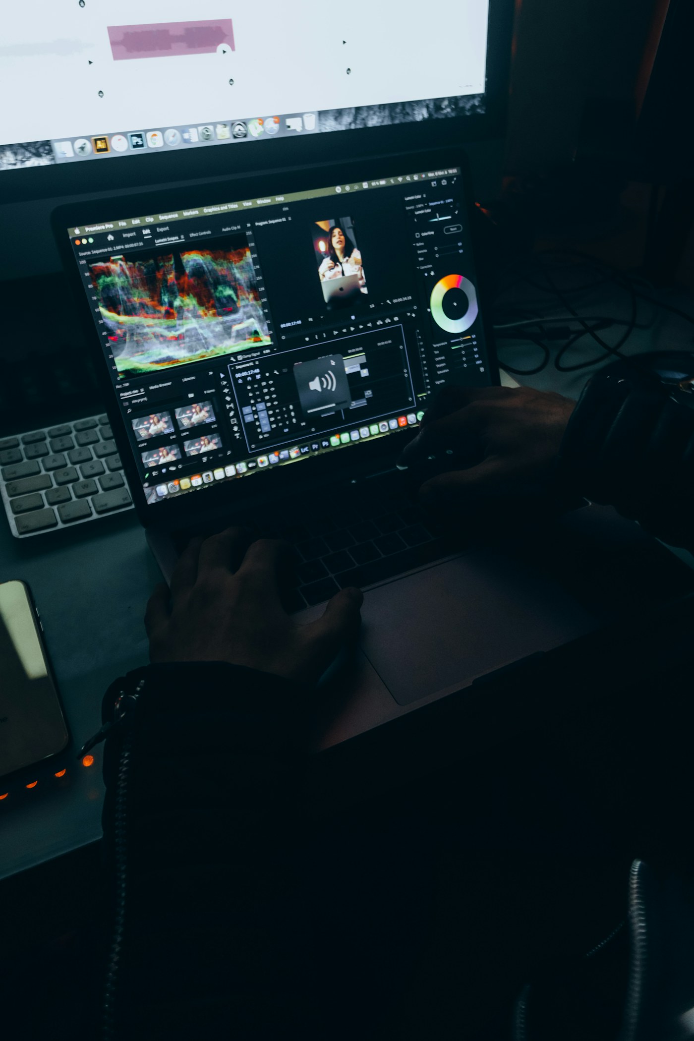 Creator editing and color grading video on a MacBook