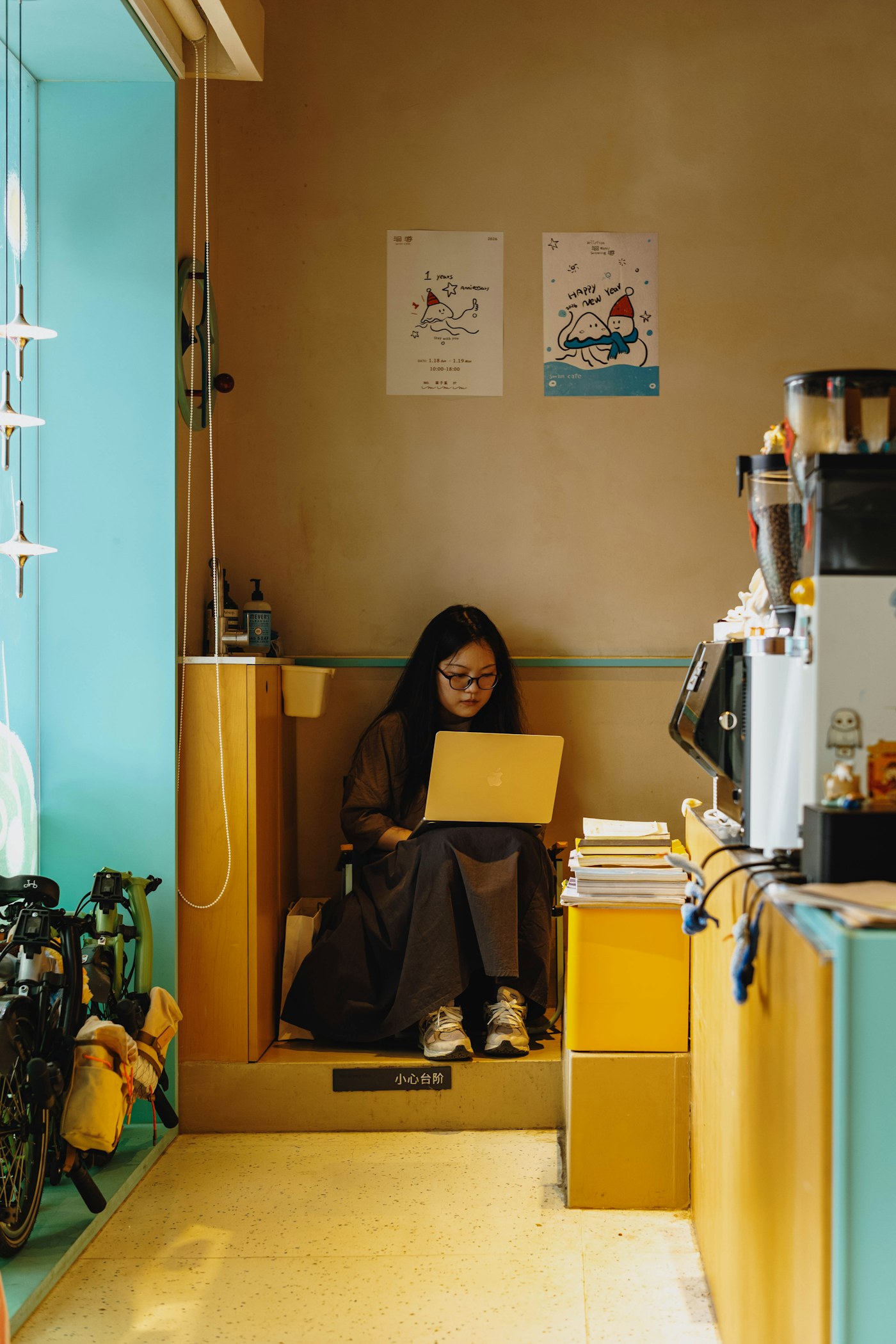 Student using a MacBook in a coffee shop